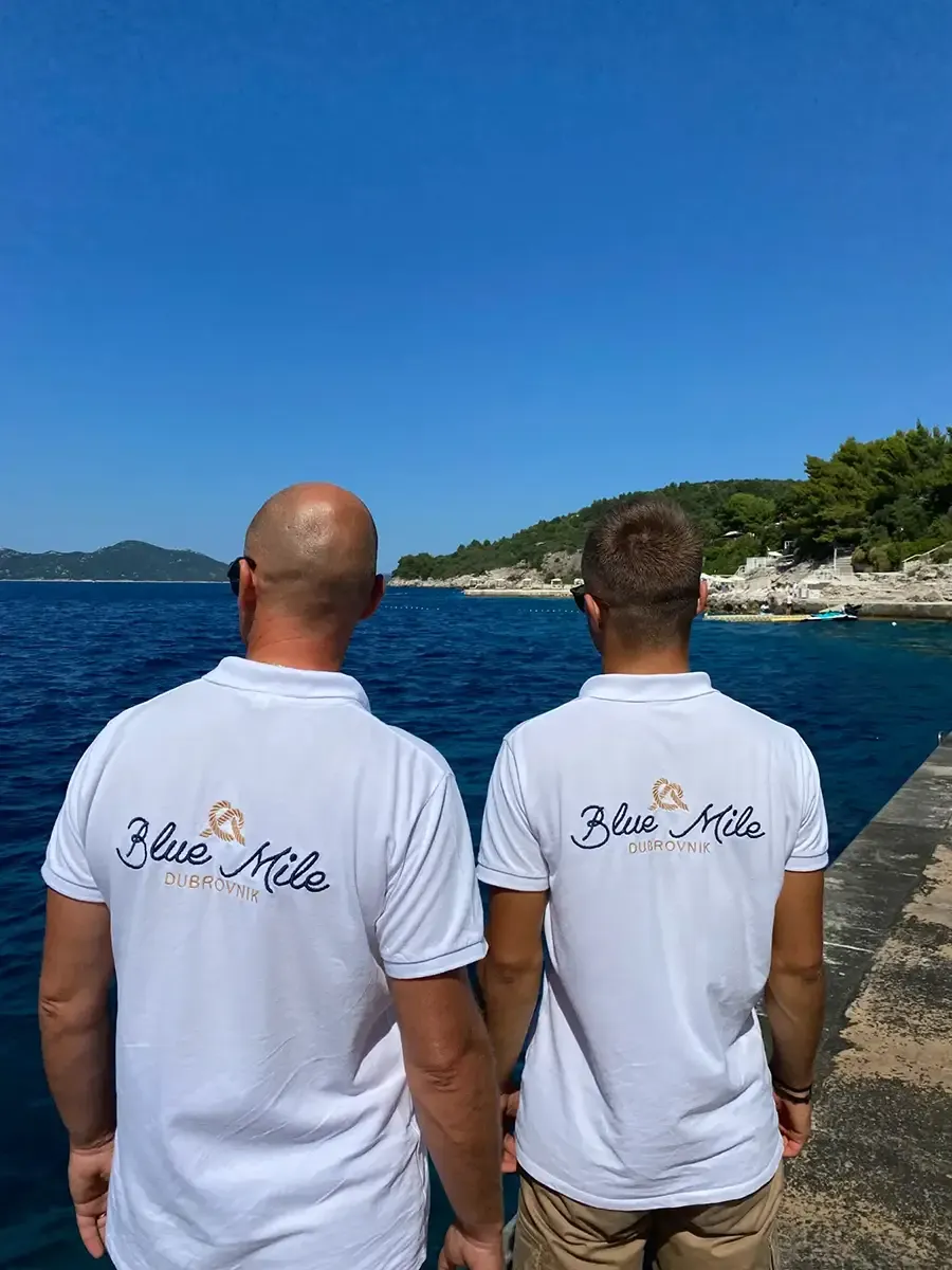Nikša and Luka in Blue Mile shirts by the Adriatic